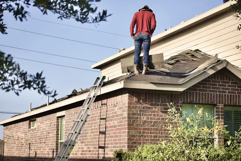 Professional roofer working on a residential roof in Golf View Manor